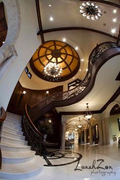 the inside of a house with stairs and chandelier