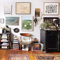 a living room filled with furniture and pictures on the wall