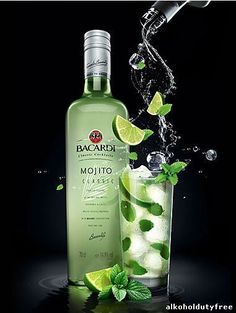 a bottle of bacardi mojito next to a glass filled with ice and limes