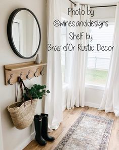 a room with a rug, mirror and boots on the floor