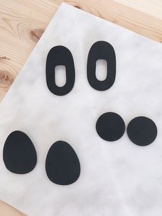 the paper is cut out to look like an animal's paw and nose with black circles on it