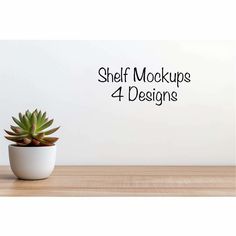 a small potted plant sitting on top of a wooden table next to a white wall