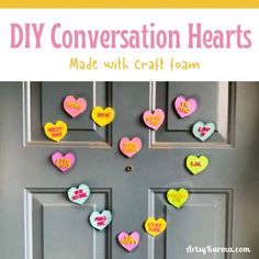 conversation hearts made with craft foam are hanging on the front door for valentine's day