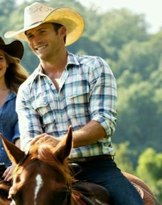 a man and woman riding on the back of a brown horse