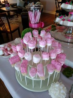 pink and white cake pops on a table