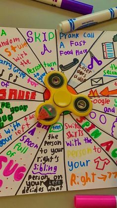 a spinner with writing on it next to markers