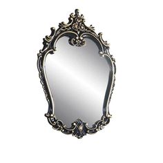 an ornate mirror is shown against a white background