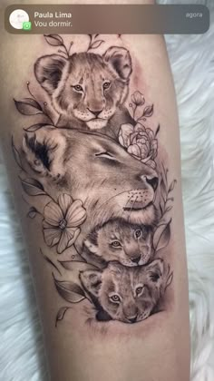 a tattoo with lions and roses on it