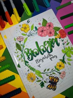 an open notebook with the words baby shower surrounded by crayons and markers