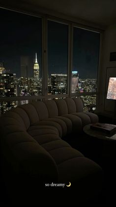 a living room filled with furniture and a flat screen tv mounted to the side of a wall