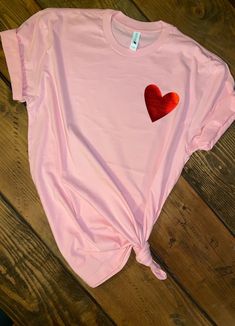 Simple and Subtle way to express your LOVE on Vday. Makes for great gift for her.. Moms, daughters, girlfriends or just yourself! Soft and comfy UNISEX T-shirt soft pink 50/50 cotton/poly 3.5x3.5 metallic red heart Available in infant, toddler, yths and adults sizes. Heat pressed with high quality siser htv and professional pressed. LAST DAY TO ORDER TO RECEIVE NORMAL MAIL IS 2/10/19. Vday Gift Ideas, Womens Valentine Shirts, Heart Tshirt, Vday Gifts, Football Mom Shirts, Valentines Day Shirt, Valentine Shirt, Valentine T Shirts, Pink Valentines