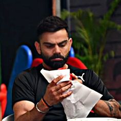 a man sitting at a table with food in front of him