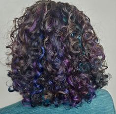 Purple Money Piece Curly Hair, Oil Spill Hair Curly, Purple Underdye Hair Curly, Pink Purple Blue Hair Highlights Dark Brown, Curly Colored Hair Aesthetic, Purple Lowlights In Brown Hair, Peekaboo Hair Color Curly, Curly Hair Peekaboo Color, Hair Dye Ideas For Curly Hair