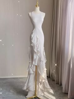 a dress on a mannequin in front of curtains