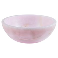 a pink bowl sitting on top of a white table