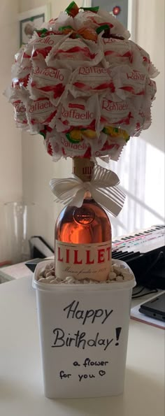 a birthday cake in a vase with candy on top