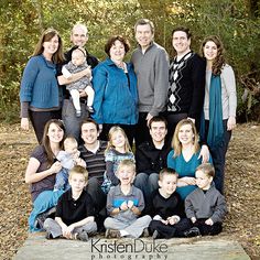 a family posing for a photo in the woods