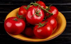 a yellow plate topped with lots of red tomatoes