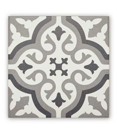 a white and grey tile with an ornate design