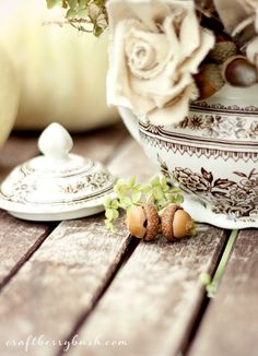 two little acorns sitting on top of a table next to a flower pot