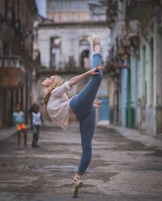 a woman is doing yoga on the street