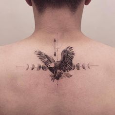 the back of a man's neck with an eagle tattoo on it