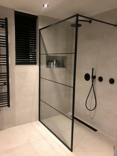 a bathroom with a walk in shower next to a radiator