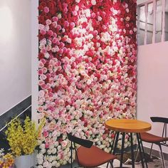 the wall is covered with pink and white flowers