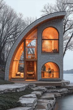 an unusual house built into the side of a body of water