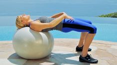 a woman is doing exercises on an exercise ball