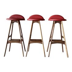 three wooden stools with red leather seats on each one and the same seat in different positions