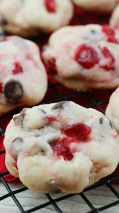 cookies with white and red toppings cooling on a rack