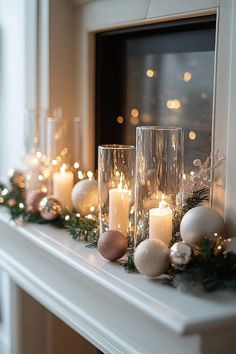 a mantle with candles and ornaments on it