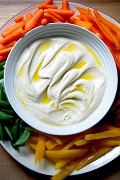 a plate with carrots, green beans and dip