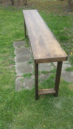 a wooden bench sitting on top of a lush green field