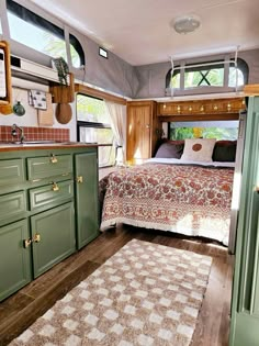 a bedroom with green cabinets and a bed