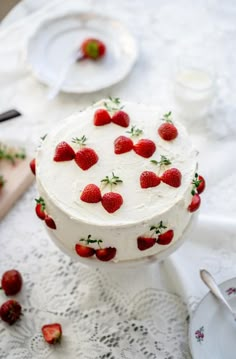 a white cake with strawberries on it