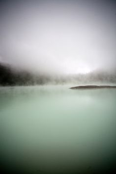 a body of water that is surrounded by fog