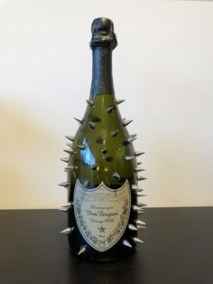 a bottle with spikes on it sitting on a table