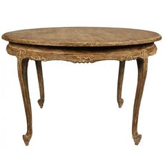 an old wooden table with two oval shaped tables on each side and one round top