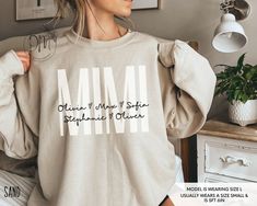 Elevate the joy of Mother's Day with our Personalized Mimi sweatshirt adorned with the sweet touch of grandkid names. This Mimi sweatshirt creates a heartfelt and stylish tribute to the cherished Mimi in your life. ✨Please check the SIZE CHART image on the listing, and choose your size accordingly before placing your order.  🚫We do not accept exchanges, returns, or cancellations, however, if there are any quality issues with the item please contact us right away. We'll be happy to make things right and make sure you are satisfied with the item you purchased! ✨ A re-shipping fee will apply if an order needs to be reshipped due to buyer's error in entering the correct shipping address. ✨ Gift messages are not available at this time -------------------------------------------------------- PL Mama Crewneck, Mimi Gift, Mama Sweater, Custom Sweaters, Kids Names, Mama Sweatshirt, Make Things, Kid Names, The Sweet