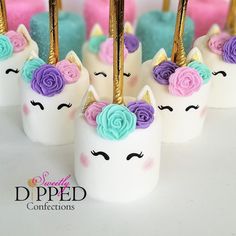 unicorn cake pops with colorful flowers on them