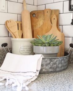 kitchen utensils and wooden cutting boards on a counter