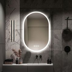 a bathroom with a round mirror above the sink