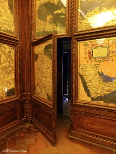 an open door leading to another room with paintings on the walls and flooring in it