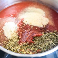 spices and seasonings are mixed in a pot on the stove top for making an appetizer