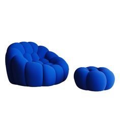 a blue chair and ottoman sitting next to each other