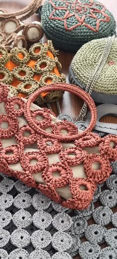 crocheted purses are sitting on a table