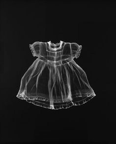 a black and white photo of a baby's dress