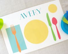 there is a place mat with the name avery on it next to a fork and knife